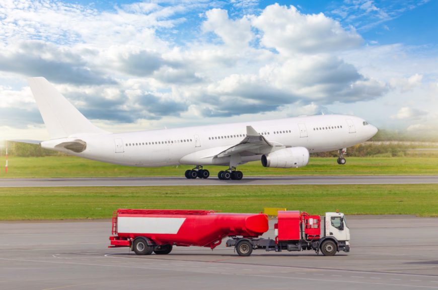  Airplane taking off at an airport, in the foreground a fuel truck