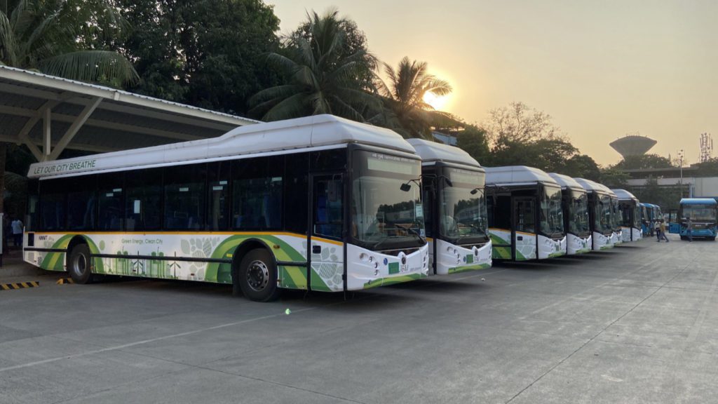 parked electric buses lined up at sunset in Navi Mumbai