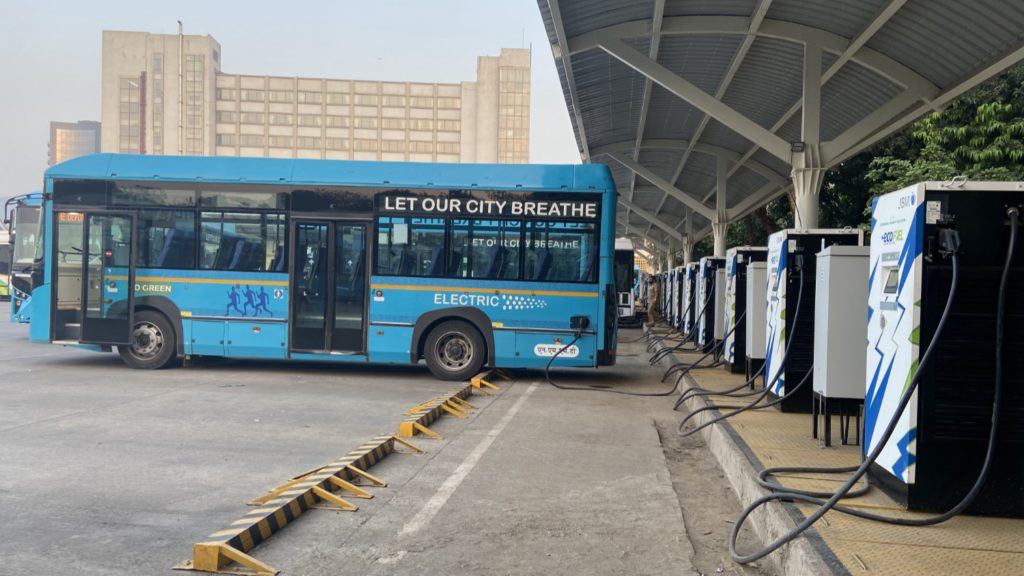 blue electric bus charging in Navi Mumbai. Bus lettering says "Let our city breathe"